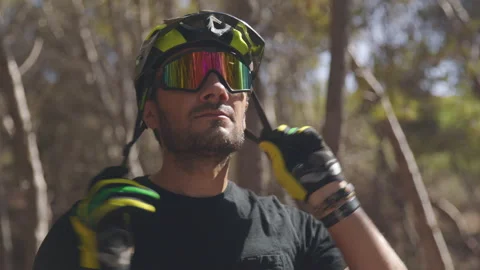 Caucasian Male Mountain Biker Putting On Helmet Stock Footage