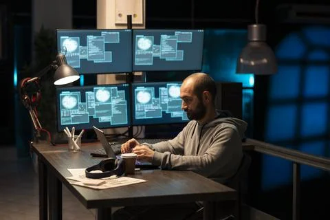 Caucasian male programmer writing code and debugging software Stock Photos