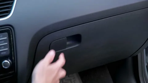 Caucasian Male Pulling Out Concealed Handgun from Car Glove Box Compartment Stock Footage 160954909
