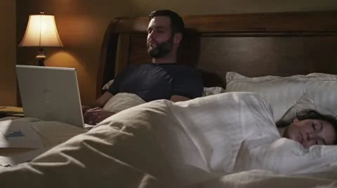 Caucasian Male Working In Bed Night Upset Stock Footage