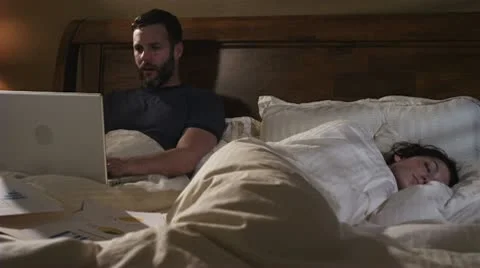 Caucasian Male Working In Bed Night Pillow Fight Stock Footage