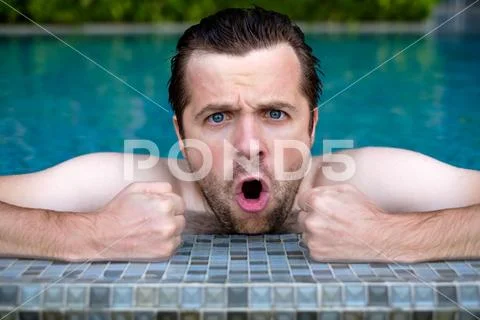 Caucasian man is angry and shout while swimming in pool. Stock Photos