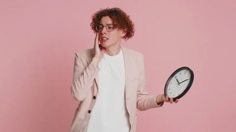 Caucasian man with anxiety checking time on clock, running late to work, being Stock Footage 277108168