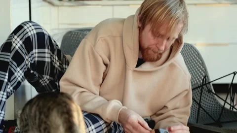 Caucasian man assembles chair sitting on kitchen floor Video stock 305944551