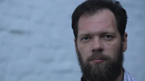 Caucasian man with a beard looking up and in different directions. male portrait Stock Footage 99077471
