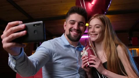 Caucasian man with beard is making a selfie with his girlfriend using a phone Stock Footage 146779770