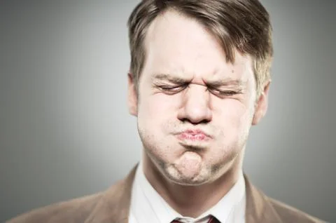Caucasian man blowing cheeks expression portrtait Stock Photos