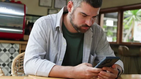 Caucasian man browsing in smartphone in cafe. Stock Footage 272586992