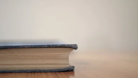 Caucasian man building a stack of old aged books Stock Footage 115688970
