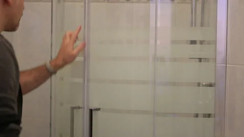 A caucasian man is checking the proper functioning of the sliding door closure Stock Footage 140898461