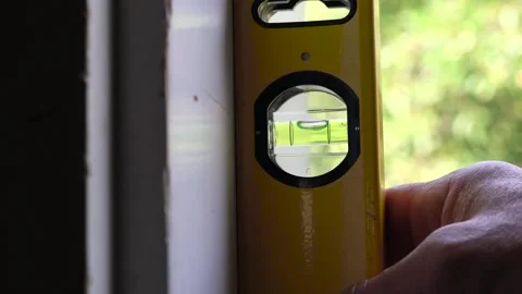 Caucasian man checking the vertical straigthness Stock Footage 313820823