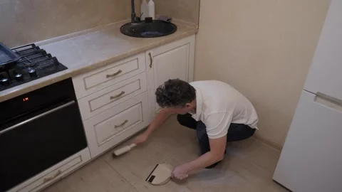 Caucasian man cleaning kitchen floor, Stock Footage 337799835