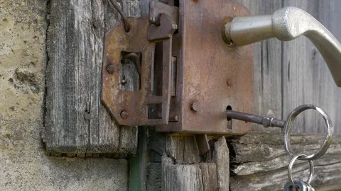 Caucasian man closing the rusty lock Stock Footage 114348210
