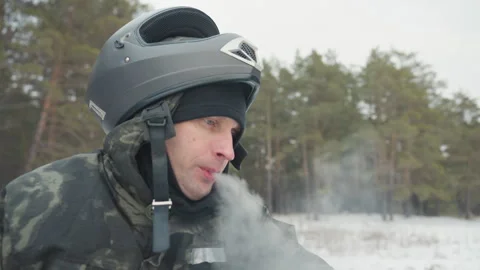 Caucasian man controls snowmobile amid trees. Individual dressed in hunting Stock Footage 345145848