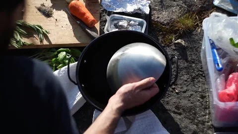 Caucasian man cooking on an open fire Stock Footage 275049707