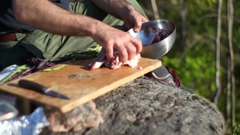 Caucasian man cooking on an open fire Stock Footage 275049736