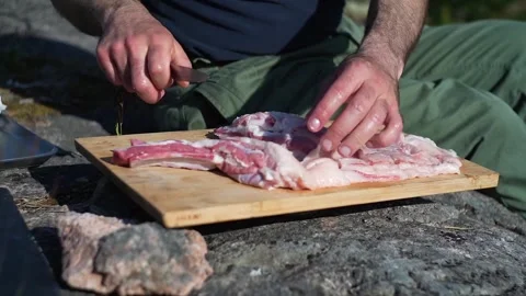 Caucasian man cooking on an open fire Stock Footage 275049772