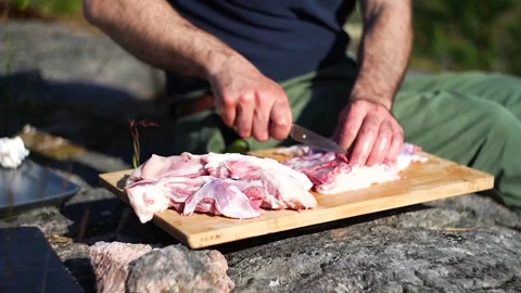 Caucasian man cooking on an open fire Stock Footage 275049805