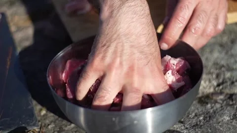 Caucasian man cooking on an open fire Stock Footage 275049825