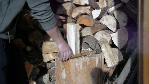 Caucasian man cutting pine fire wood with an axe Stock Footage 98133797