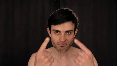 Caucasian man dancing funny in front of the camera, on a black background Stock Footage 128913776