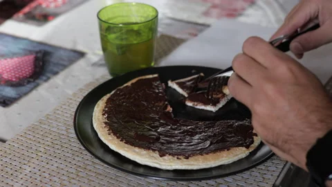 Caucasian man does breakfast with a pancake and a cup of tea. Healthy meal. Stock Footage 140862471