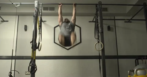 Caucasian man doing pull-ups exercises in gym. Body posity and well-being Stock Footage 166533887