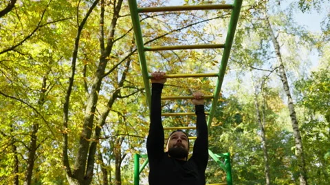 Caucasian man doing pull-ups on the bar Stock Footage 236817004