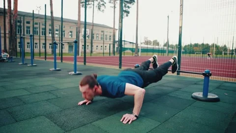 Caucasian man doing push-up physical exercises, exercising on the outdoor Stock Footage 149750049