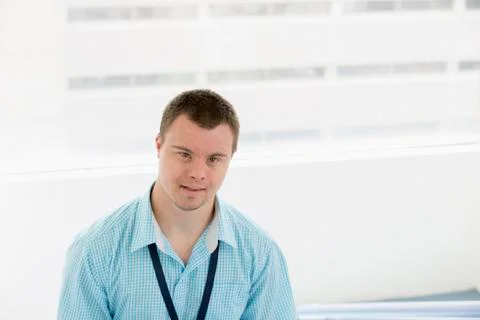 Caucasian man with Down Syndrome smiling in hospital 库存照片
