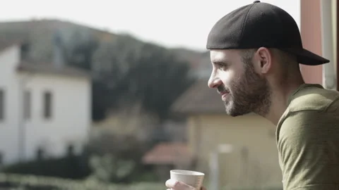 Caucasian man drinks a cup of tea outdoor for break or breakfast. Day light Stock Footage 149112944