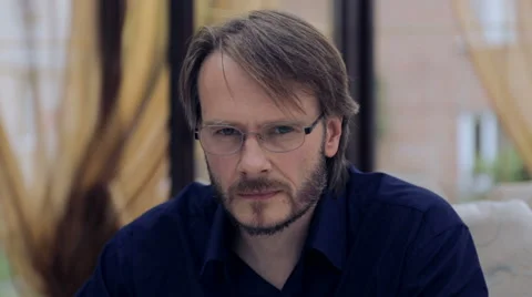 Caucasian man with glasses looking at the camera. Portrait of emotional man. Stock Footage 51587068
