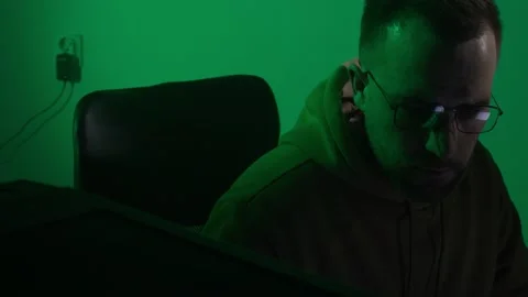 A caucasian man in glasses works on the computer, coding, studying, programming Stock Footage 147605989