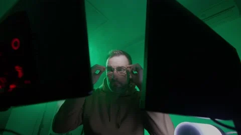 A caucasian man in glasses works on the computer, inputs code, types very fast Stock Footage 147606535