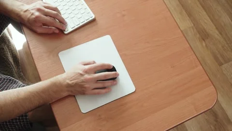 Caucasian man hand moves wireless mouse on desk mat, clicking and scrolling. 스톡 동영상 330541907