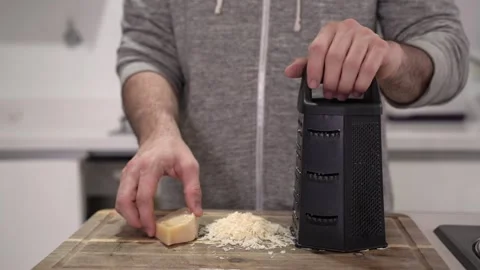 A caucasian man hands grating cheese Stock Footage 279999096