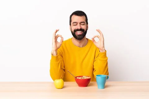 Caucasian man having breakfast in a table in zen pose Stock Photos