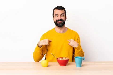 Caucasian man having breakfast in a table pointing to oneself Stock Photos