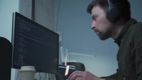 Caucasian man in headphones IT coder programmer software engineer use laptop Stock Footage 153499564