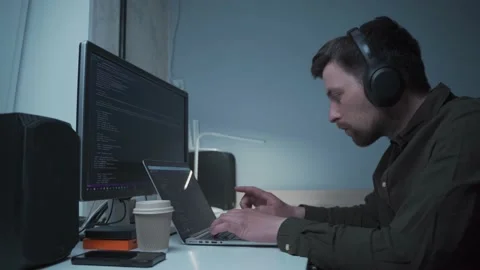 Caucasian man in headphones IT coder programmer software engineer use laptop Stock Footage 153499788