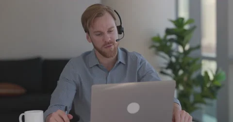 Caucasian man at home remote working on laptop computer Vidéo 169474528