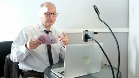 Caucasian man, hot, fanning himself with money. Stock Footage
