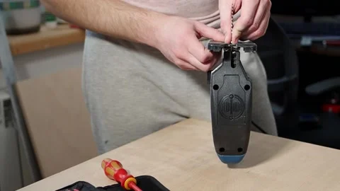 Caucasian man inserts metal blade into an electric jig saw and fixes it Stock Footage 236754403