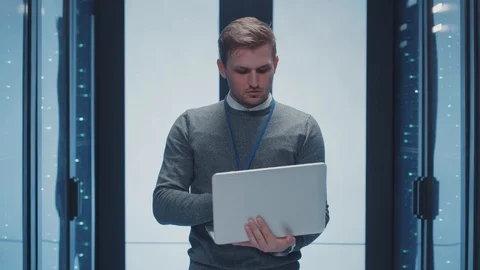 Caucasian man IT professional doing cloud-based data transfer with laptop Stock Footage 125519228