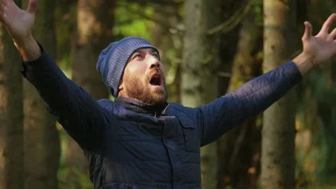 Caucasian man in jacket and ski cap screaming expressive held up his hands Stock Footage 144189768