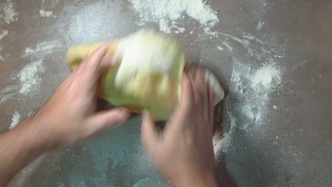 Caucasian man kneading dough. Bread making. Pizza making on Floured Countertop Stock Footage 124365175