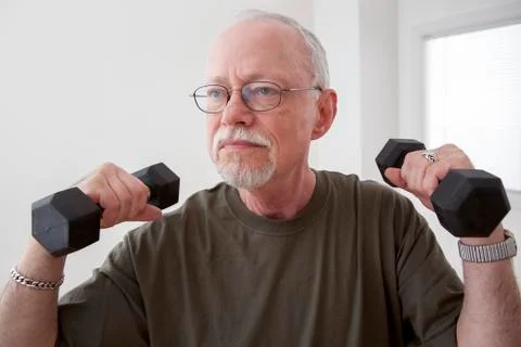 Caucasian man lifting weights Stock Photos