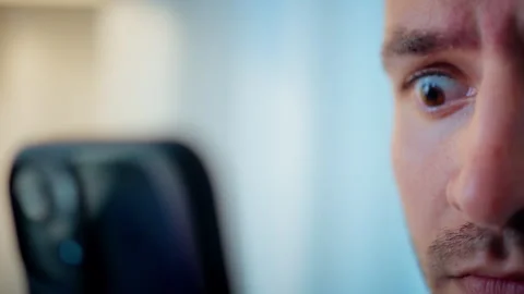 Caucasian man looking surprised at his cell phone. Close up Stock Footage 317543671