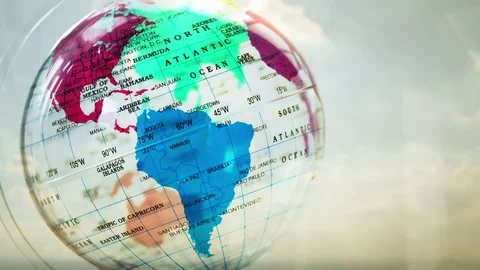 A caucasian man looking at a transparent globe backlit by the sun Video stock 85118747