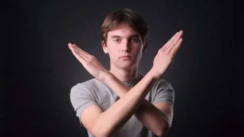 Caucasian Man Making Stop Gesture with Crossed Arms on black Background Stock Footage 257460586